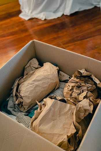 Picture of packed fragile items in cardboard box.